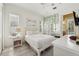 Bright bedroom with neutral colors, a large window, and a decorative hanging chair at 9684 Sweetleaf St, Orlando, FL 32827