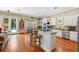 Kitchen featuring a breakfast bar, stainless steel appliances, custom white cabinets, and seamless flow to dining area at 9684 Sweetleaf St, Orlando, FL 32827