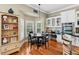 Kitchen with breakfast nook featuring a modern light fixture, neutral paint, and views of the lush landscaping at 9684 Sweetleaf St, Orlando, FL 32827