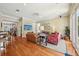 Spacious living room with hardwood floors, ceiling fan, neutral paint, and bright natural light at 9684 Sweetleaf St, Orlando, FL 32827