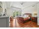 Main bedroom showcasing tray ceilings, french doors to the balcony, hardwood floors, and neutral paint at 9684 Sweetleaf St, Orlando, FL 32827