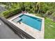 A sparkling pool with a sundeck and lounge area is surrounded by lush landscaping for ultimate privacy at 9684 Sweetleaf St, Orlando, FL 32827
