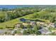Beautiful aerial view of a neighborhood with lush greenery and a serene pond at 11025 Ledgement Ln, Windermere, FL 34786