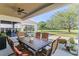 Relaxing porch with outdoor dining, a ceiling fan, and a view of the lush backyard at 11025 Ledgement Ln, Windermere, FL 34786
