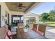 Comfortable outdoor dining space with ceiling fan on a covered porch at 11025 Ledgement Ln, Windermere, FL 34786