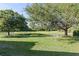 Large backyard features mature trees and a picturesque pond view at 11025 Ledgement Ln, Windermere, FL 34786