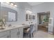 Bright bathroom vanity with double sinks, makeup area, and views to bedroom at 11025 Ledgement Ln, Windermere, FL 34786