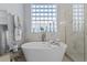 Stylish bathroom featuring a standalone tub, elegant fixtures, and natural lighting at 11025 Ledgement Ln, Windermere, FL 34786