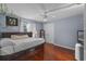 Cozy bedroom with wood floors, ceiling fan and a relaxing, pale-blue wall color at 11025 Ledgement Ln, Windermere, FL 34786