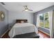 Comfortable bedroom with hardwood floors, ceiling fan and large window at 11025 Ledgement Ln, Windermere, FL 34786