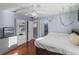 Bedroom with hardwood floors, ceiling fan, walk-in closet, and an attached bathroom at 11025 Ledgement Ln, Windermere, FL 34786