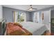 Comfortable bedroom with hardwood floors, view to pond, and ensuite bath at 11025 Ledgement Ln, Windermere, FL 34786