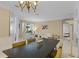 Stylish dining area with tile floors, modern chandelier, and large windows for natural light at 11025 Ledgement Ln, Windermere, FL 34786