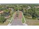 Brick paved community entrance featuring manicured landscaping and tall palm trees on a sunny day at 11025 Ledgement Ln, Windermere, FL 34786