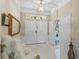 Elegant foyer with bright tile floors, double front doors, and modern light fixtures create a welcoming entry at 11025 Ledgement Ln, Windermere, FL 34786