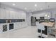 Bright kitchen features white cabinetry, stainless steel appliances, a wine cooler, and a breakfast bar at 11025 Ledgement Ln, Windermere, FL 34786