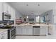 Open kitchen with an island, stainless steel appliances, and views to the living room at 11025 Ledgement Ln, Windermere, FL 34786