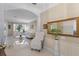 Spacious living area with bright tile floors, stylish decor, and large windows offering plenty of natural light at 11025 Ledgement Ln, Windermere, FL 34786