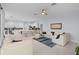 Open-concept living room featuring tile flooring, white couches, and views to the kitchen at 11025 Ledgement Ln, Windermere, FL 34786