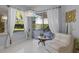 Bright living room with white tile, modern lighting, and a large window overlooking the yard at 11025 Ledgement Ln, Windermere, FL 34786