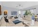 Living room featuring white couches, blue accents, and natural light at 11025 Ledgement Ln, Windermere, FL 34786