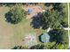 Aerial view of park with playground, basketball court, gazebo, large trees, and walking path at 11025 Ledgement Ln, Windermere, FL 34786