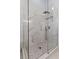 Modern shower with frameless glass enclosure and decorative tile at 11025 Ledgement Ln, Windermere, FL 34786