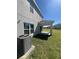 The exterior of the home features a covered patio for enjoying the backyard at 1116 Myrtle Hammock Ln, Davenport, FL 33837