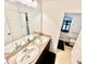 Bright bathroom featuring a double vanity with granite countertops, a large mirror, and a separate toilet room at 1116 Myrtle Hammock Ln, Davenport, FL 33837