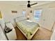 Well-lit bedroom with a bed that has a tufted headboard, large windows, and a spacious closet for storage at 1116 Myrtle Hammock Ln, Davenport, FL 33837