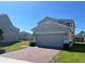 Two-story home with a two car garage, a brick driveway, and neatly manicured landscaping at 1116 Myrtle Hammock Ln, Davenport, FL 33837