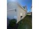 Side view of home showing landscaped yard, security camera, and easy access for maintenance at 1116 Myrtle Hammock Ln, Davenport, FL 33837