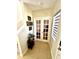 Foyer with tiled floor, French doors, window with blinds and stairway at 1116 Myrtle Hammock Ln, Davenport, FL 33837