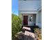 Inviting front entrance featuring a red door, brick path, and lush landscaping at 1116 Myrtle Hammock Ln, Davenport, FL 33837