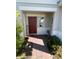 Charming front door with decorative welcome sign and well-maintained landscape at 1116 Myrtle Hammock Ln, Davenport, FL 33837