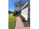 Charming front entrance with red door, brick walkway, shrubs and green lawn at 1116 Myrtle Hammock Ln, Davenport, FL 33837
