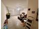 Open garage space with white walls, a concrete floor, and an open garage door providing lots of natural light at 1116 Myrtle Hammock Ln, Davenport, FL 33837