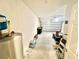 Spacious garage featuring white walls, concrete floor, and ample storage with a water heater and trash receptacle at 1116 Myrtle Hammock Ln, Davenport, FL 33837