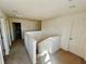 Upstairs hallway featuring carpeting, white walls, and doors leading to other rooms of the house at 1116 Myrtle Hammock Ln, Davenport, FL 33837