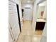 Hallway with tile flooring, a pantry, and a view into a powder room with a vanity at 1116 Myrtle Hammock Ln, Davenport, FL 33837