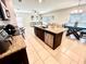 Open-concept kitchen featuring a central island with granite countertops, stainless steel appliances, and an adjacent dining area at 1116 Myrtle Hammock Ln, Davenport, FL 33837