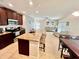 Open concept kitchen and living space with stainless steel appliances and neutral paint colors at 1116 Myrtle Hammock Ln, Davenport, FL 33837