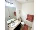 Clean powder room with a vanity, decorative mirror, and a neutral color scheme at 1116 Myrtle Hammock Ln, Davenport, FL 33837