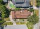 An aerial view showcasing the home's roof, landscaping, and proximity to a pool and neighboring houses at 1122 Vassar St, Orlando, FL 32804