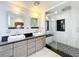 Modern bathroom features a large walk-in shower with dual sinks and sleek vanities at 1122 Vassar St, Orlando, FL 32804
