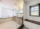 Elegant bathroom featuring dual sinks, vanity, tiled floors, large soaking tub, and bright natural light at 1122 Vassar St, Orlando, FL 32804