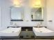 Modern bathroom featuring dual vessel sinks, black granite countertops, and unique mirrors at 1122 Vassar St, Orlando, FL 32804
