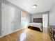 Neutral bedroom with wood floors, one window and traditional furnishing. Great for relaxing at 1122 Vassar St, Orlando, FL 32804