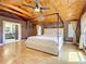 Spacious bedroom featuring a unique wood ceiling, four-poster bed, and ample natural light at 1122 Vassar St, Orlando, FL 32804