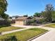 Lovely single-story home featuring a well-manicured lawn, brick driveway, and a stylish black fence at 1122 Vassar St, Orlando, FL 32804